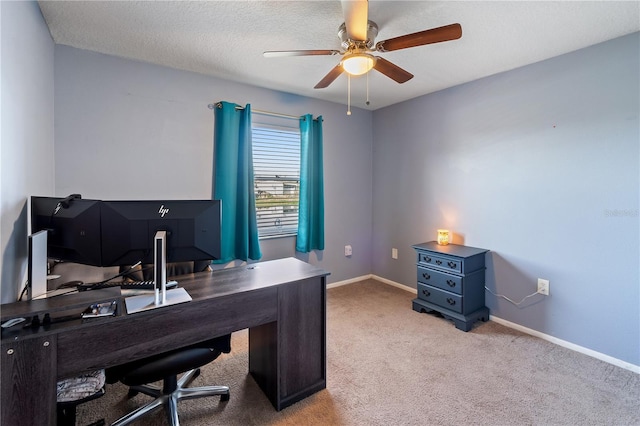 home office with light carpet, a textured ceiling, and ceiling fan