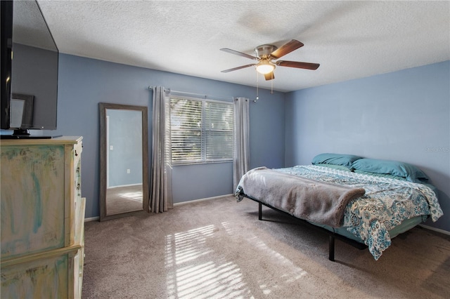 carpeted bedroom with a textured ceiling and ceiling fan