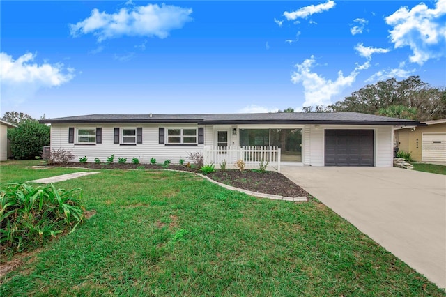 single story home featuring a front yard, a porch, and a garage