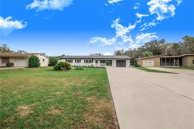 single story home featuring a sunroom, a front lawn, and a garage