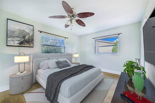 bedroom with ceiling fan and light hardwood / wood-style flooring