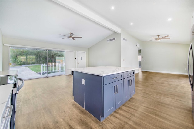 kitchen featuring blue cabinetry, lofted ceiling with beams, light hardwood / wood-style floors, and a kitchen island