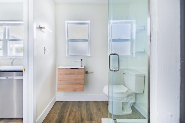 bathroom featuring vanity, hardwood / wood-style flooring, toilet, and an enclosed shower