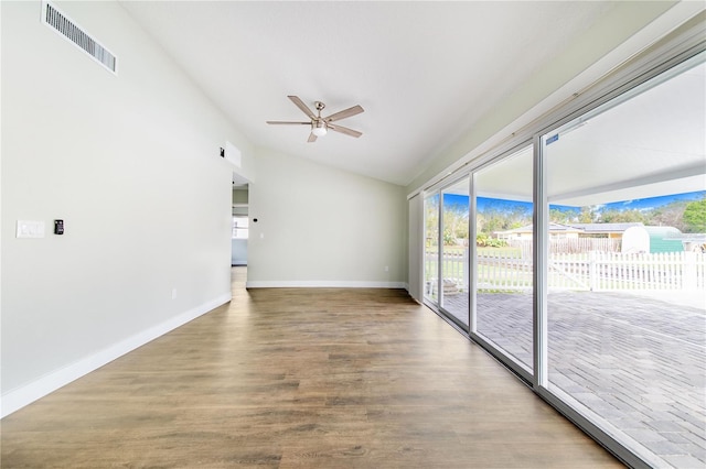 unfurnished room with wood-type flooring, vaulted ceiling, and ceiling fan