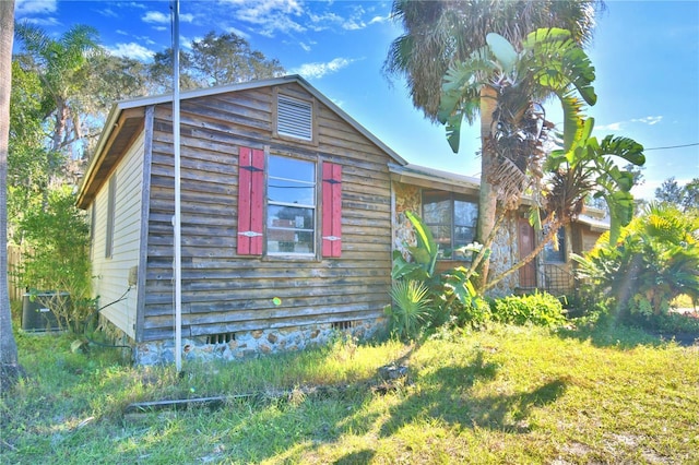 view of property exterior featuring a lawn