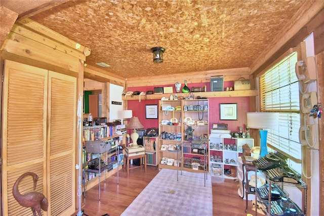 home office featuring hardwood / wood-style flooring and wood walls