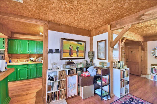 kitchen with light hardwood / wood-style floors and green cabinetry