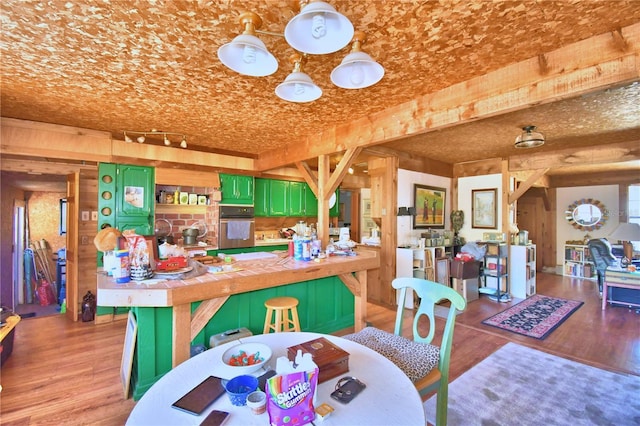 dining area featuring light wood-type flooring and wooden walls