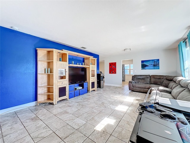 unfurnished living room with light tile patterned floors