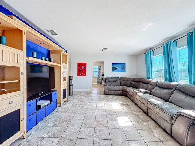 living room featuring built in shelves and a textured ceiling