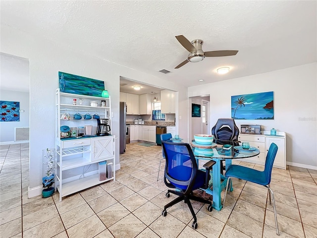 dining room with ceiling fan, light tile patterned floors, and a textured ceiling