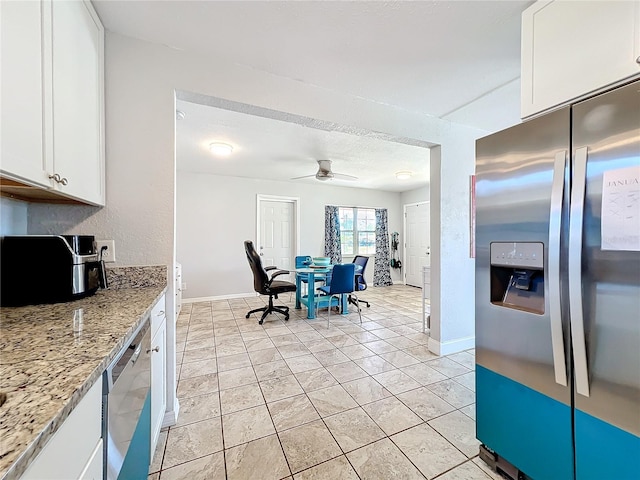 kitchen featuring appliances with stainless steel finishes, white cabinetry, ceiling fan, and light stone counters