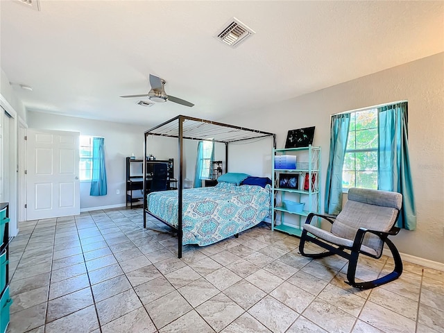 tiled bedroom with ceiling fan