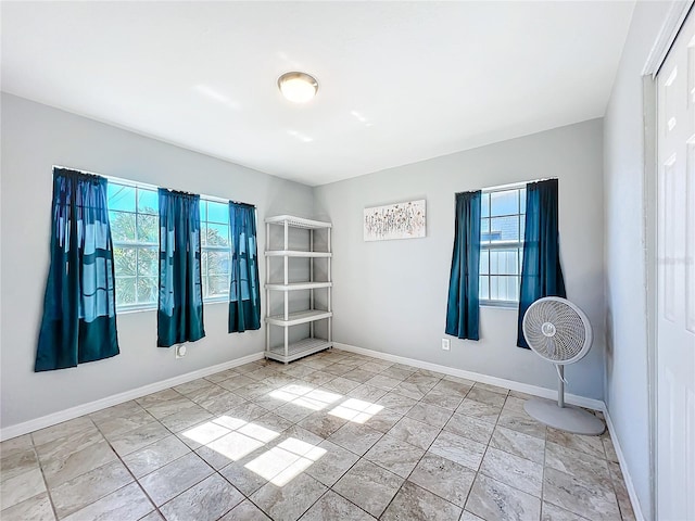 unfurnished room featuring a healthy amount of sunlight