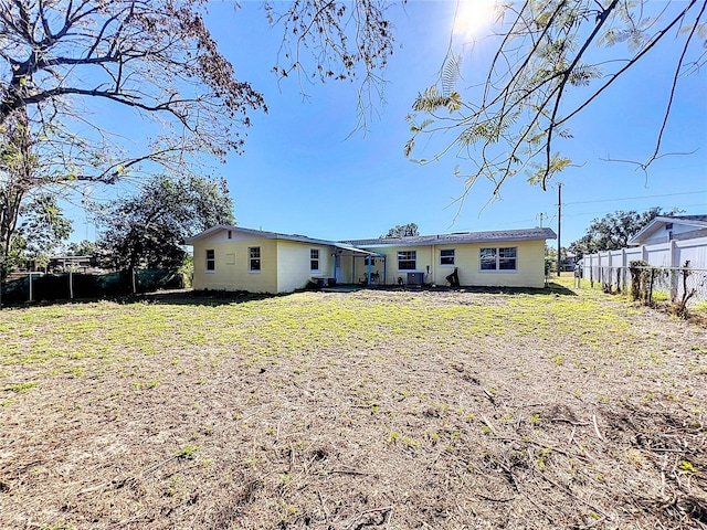 rear view of property featuring a yard