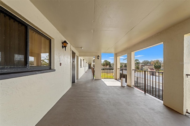 view of patio / terrace featuring elevator and a balcony