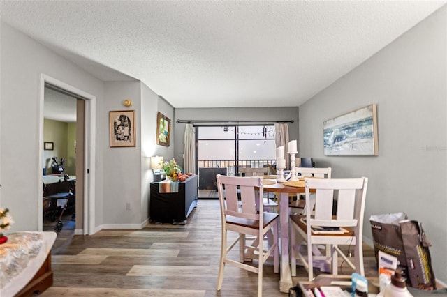 dining room featuring hardwood / wood-style floors and a textured ceiling