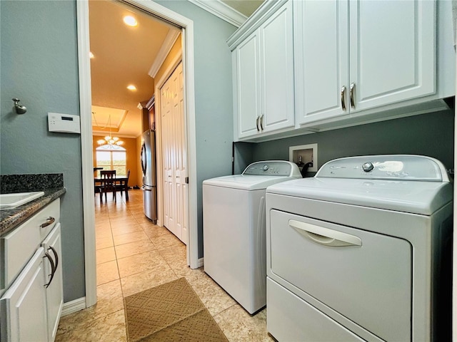 laundry room featuring cabinets, an inviting chandelier, crown molding, separate washer and dryer, and light tile patterned floors