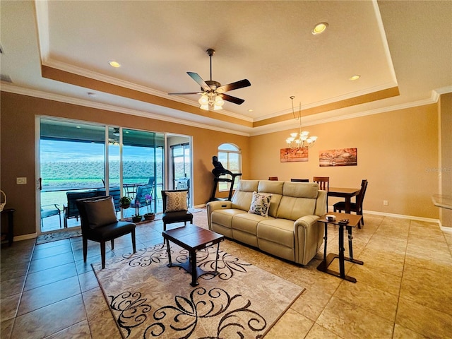 tiled living room featuring ceiling fan with notable chandelier, a raised ceiling, and ornamental molding