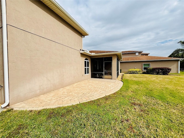 view of yard featuring a patio and a sunroom