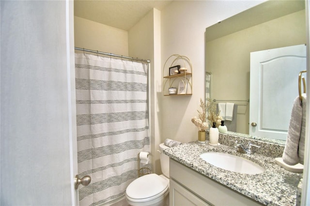 bathroom featuring vanity, toilet, and curtained shower