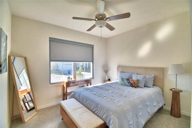 bedroom featuring light colored carpet and ceiling fan