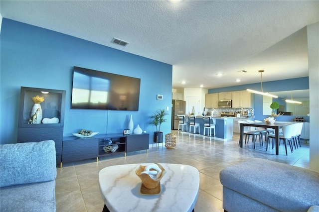 tiled living room with a textured ceiling