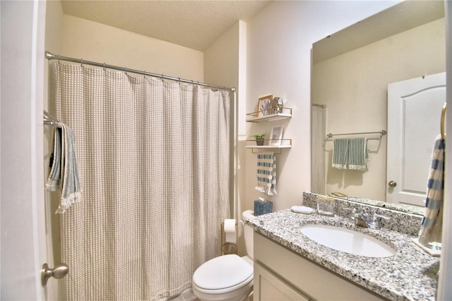 bathroom featuring vanity, a textured ceiling, and toilet