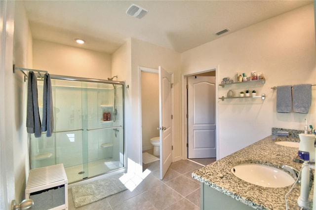 bathroom featuring tile patterned flooring, heating unit, toilet, a shower with door, and vanity