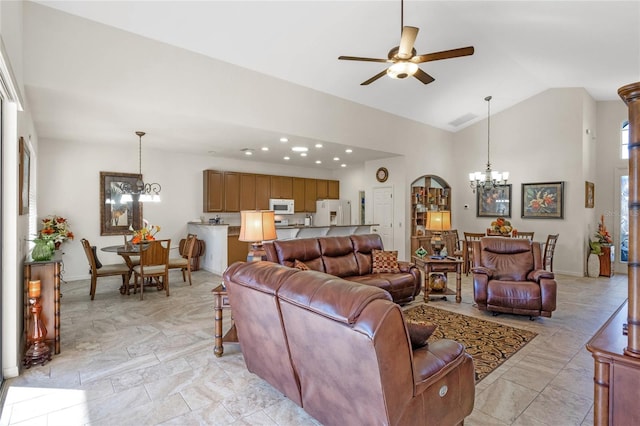 living room featuring baseboards, visible vents, high vaulted ceiling, and ceiling fan with notable chandelier