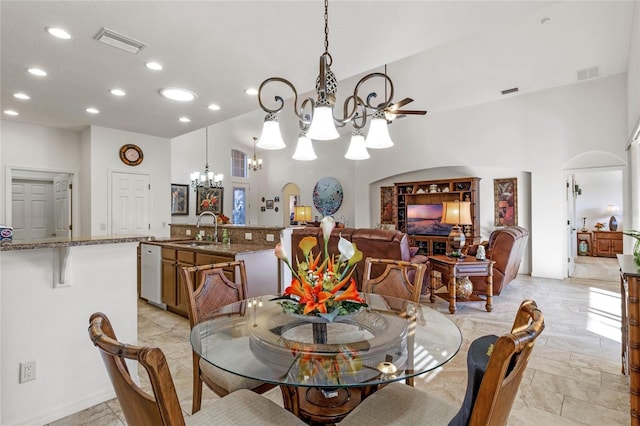 dining space with arched walkways, visible vents, and a notable chandelier