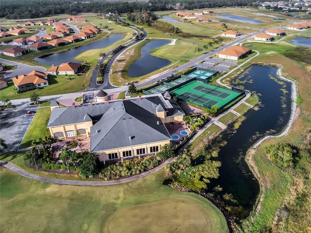 birds eye view of property featuring golf course view, a water view, and a residential view