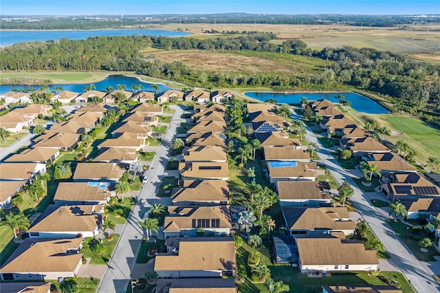 birds eye view of property featuring a water view, view of golf course, and a residential view