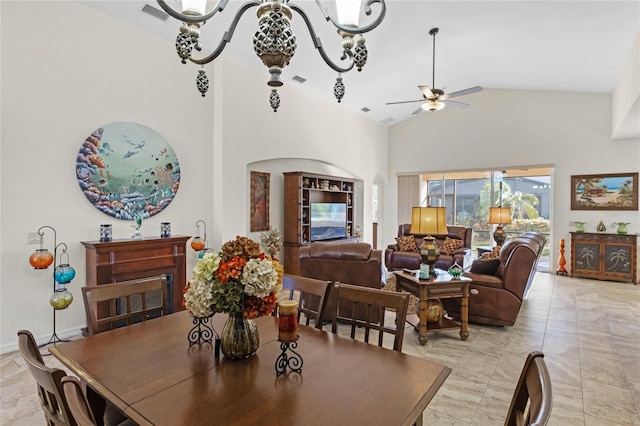 dining area with high vaulted ceiling, arched walkways, visible vents, and ceiling fan with notable chandelier