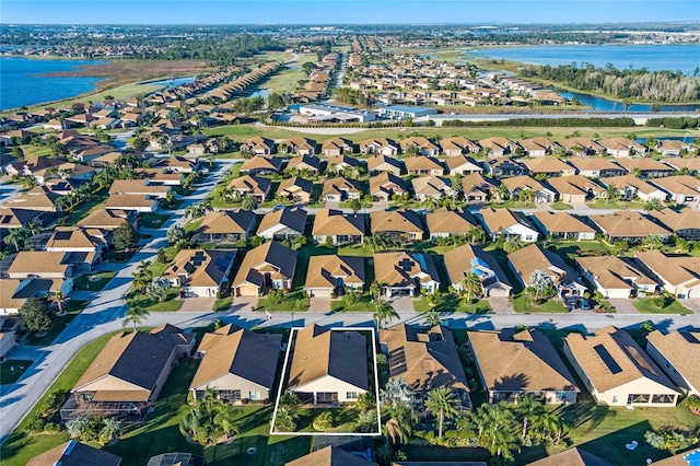 drone / aerial view featuring a water view and a residential view