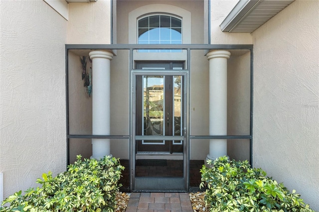 view of exterior entry with stucco siding