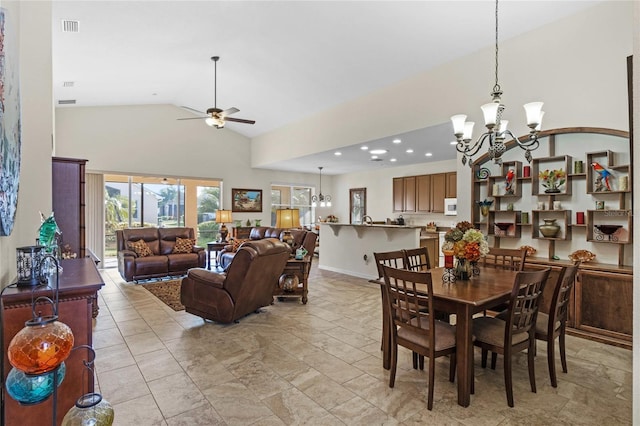 dining space with high vaulted ceiling, recessed lighting, ceiling fan with notable chandelier, visible vents, and baseboards