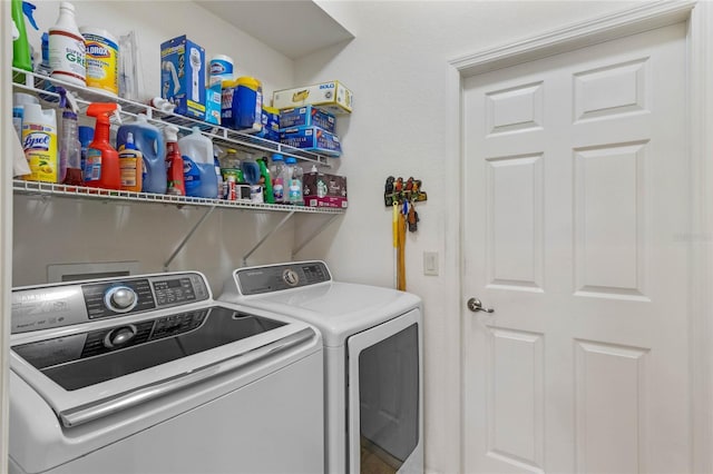 clothes washing area featuring laundry area and washer and clothes dryer