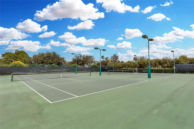 view of sport court featuring fence