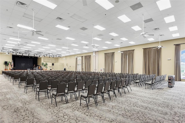 misc room featuring a drop ceiling, carpet, visible vents, and a ceiling fan