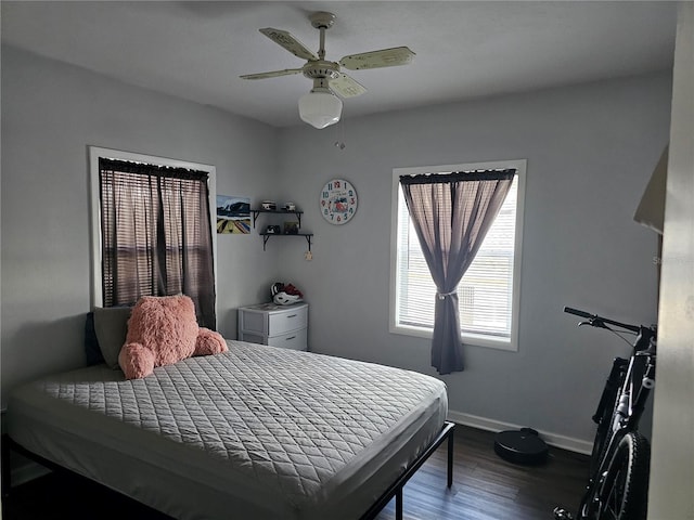 bedroom featuring ceiling fan and dark wood-type flooring