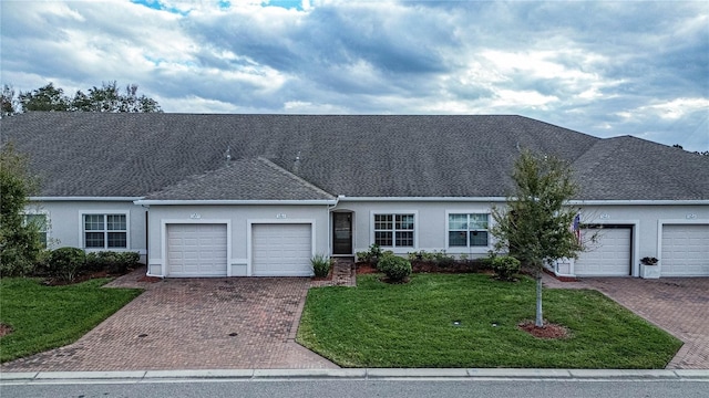 ranch-style home with a front lawn and a garage