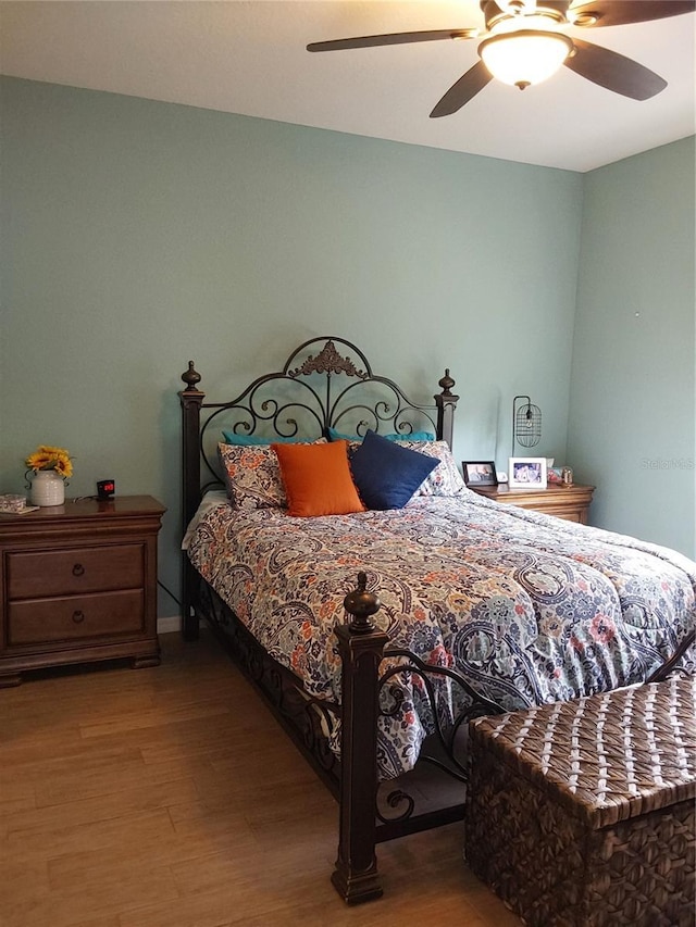 bedroom featuring hardwood / wood-style floors and ceiling fan