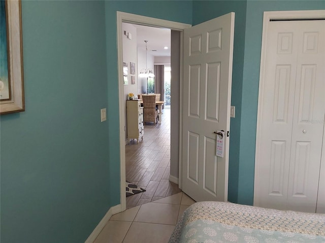 bedroom with a chandelier, a closet, and light tile patterned floors