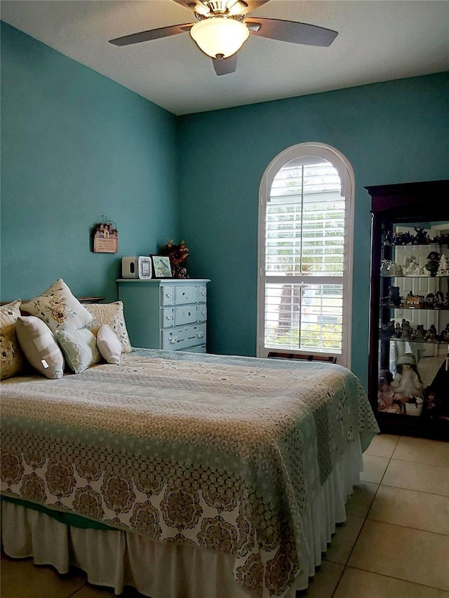 tiled bedroom featuring ceiling fan