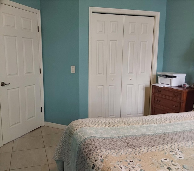 tiled bedroom with a closet