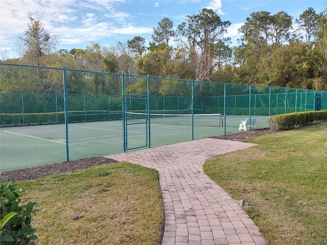 view of sport court featuring a lawn