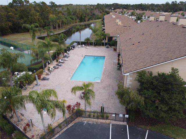 view of pool with a water view and a patio area