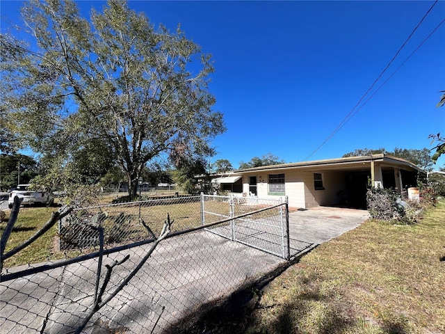 back of property featuring a yard and a carport