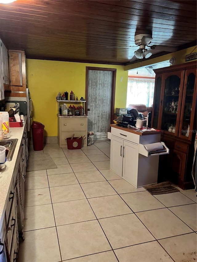 kitchen with white cabinets, light tile patterned flooring, ceiling fan, and wood ceiling